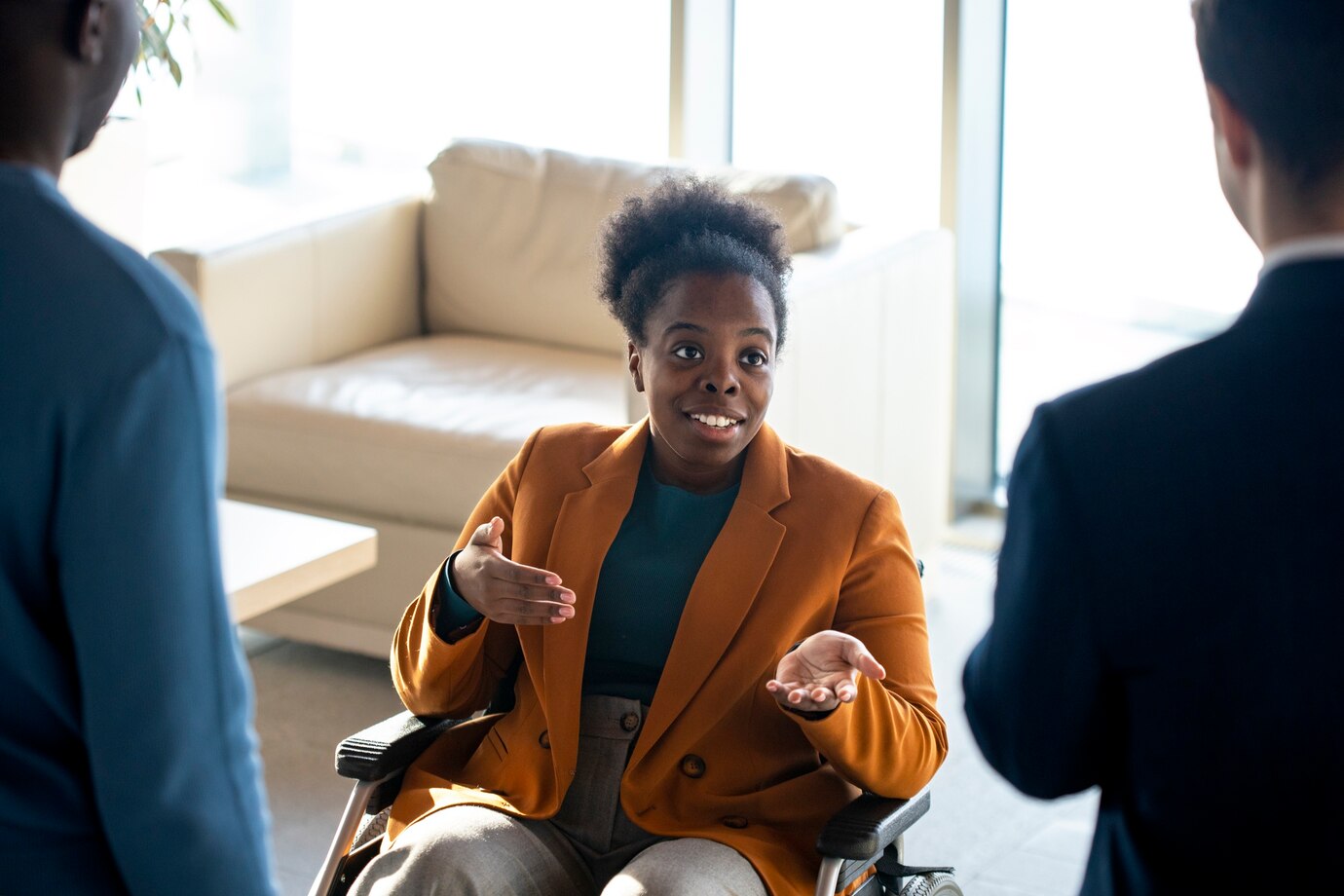 close-up-smiley-woman-chatting-with-colleagues_23-2149304772