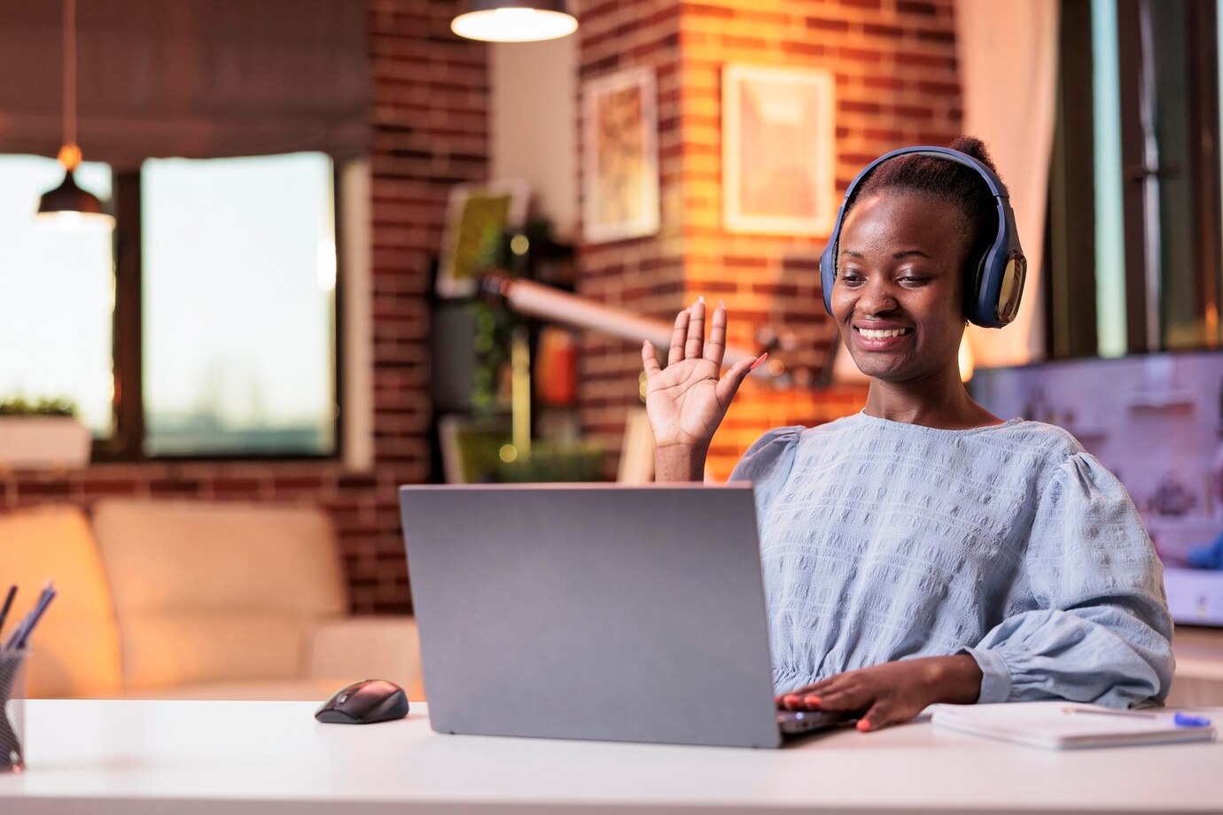 smiling-african-american-female-remote-worker-greeting-colleagues-videocall-modern-home-office-videoconference-meeting-with-company-team-businesswoman-headphones-teleconference_482257-